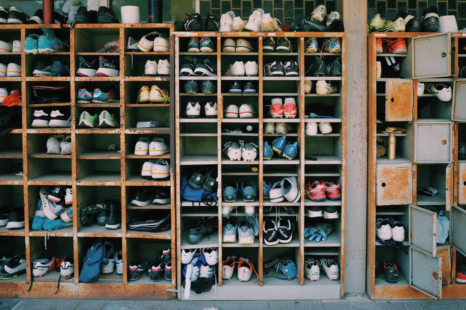 Rows of shoes stored on open shelving