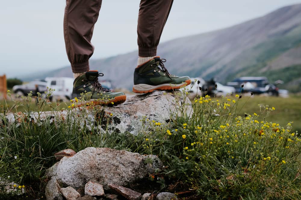 Hiking boots on a rocky trail, wet from the ground