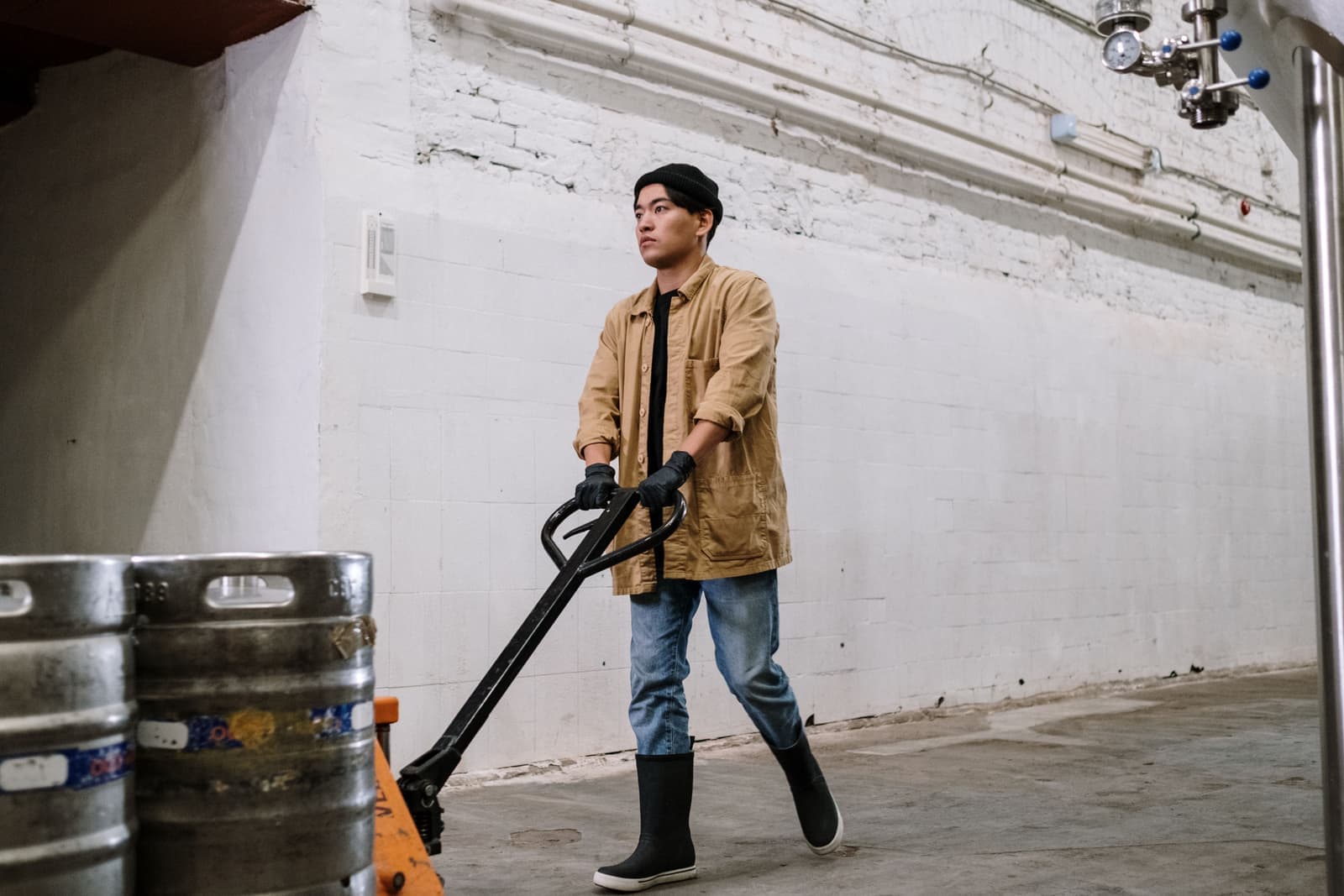 A worker moving heavy items in an industrial workplace