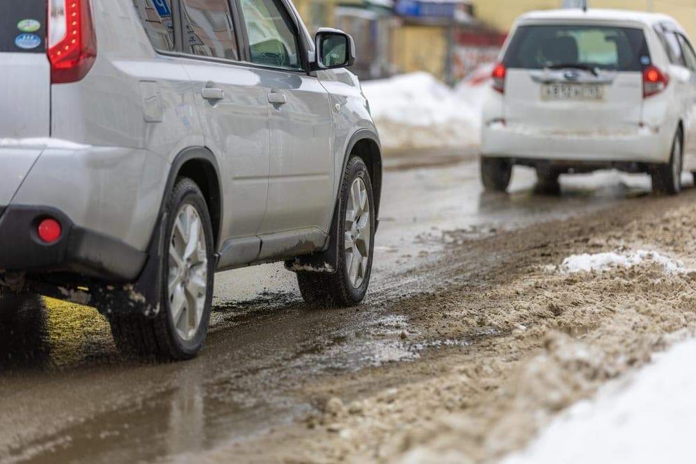 A snow-covered city street treated for winter conditions