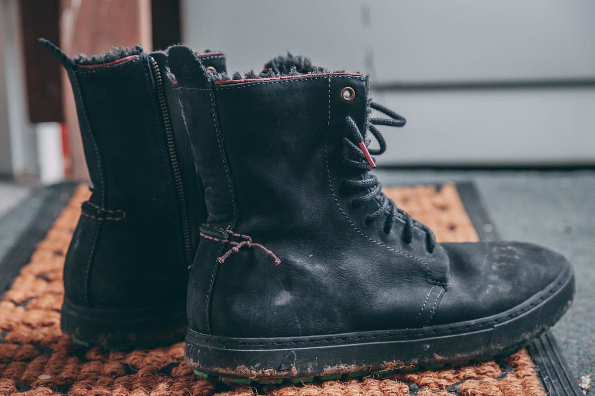 Wet boots set out to dry indoors in warm air