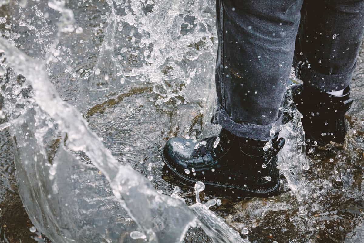 A waterproofing treatment being applied to a leather boot